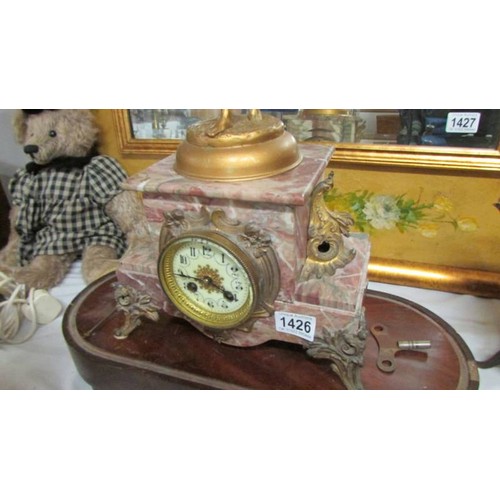 1426 - An early French marble and ormolu mantel clock surmounted figure. in working order.