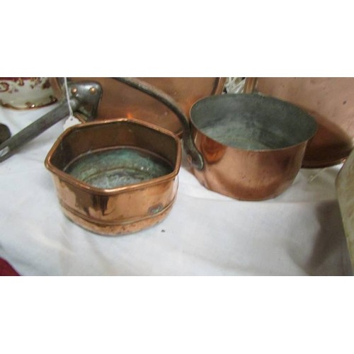 1428 - Two 19th-century copper pan lids, a copper saucepan and another copper pan.