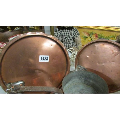 1428 - Two 19th-century copper pan lids, a copper saucepan and another copper pan.