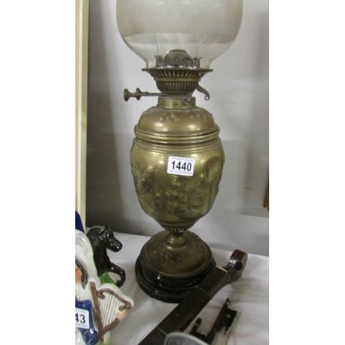 1440 - A Victorian brass oil lamp complete with shade.