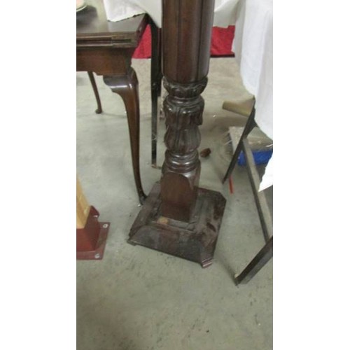 1479 - A tall mahogany torchere.