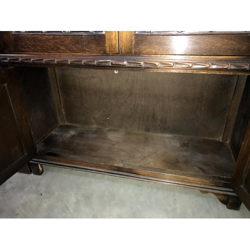 234 - A dark oak priory style display cabinet with cupboard base & leaded glass doors (95cm x 32cm x 137cm... 