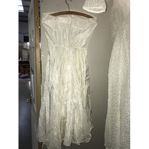 304 - A white vintage lacey wedding dress with white under garment