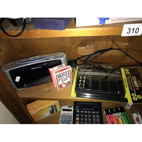 310 - A quantity of sundry electrical & electronic goods including phones, radio's & a massager etc. (3 sh... 