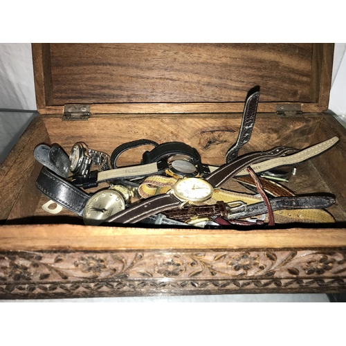 321 - A mixed lot of wristwatches in a carved wooden box