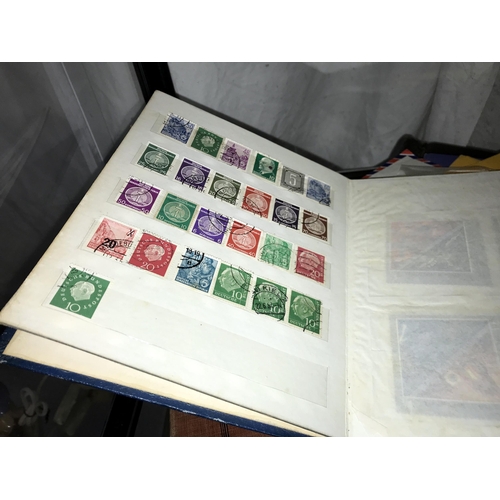 331 - 4 small stamp albums and a quantity of loose stamps