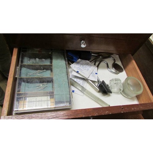 1547 - A 1960's dentist's cabinet containing dentist's equipment.