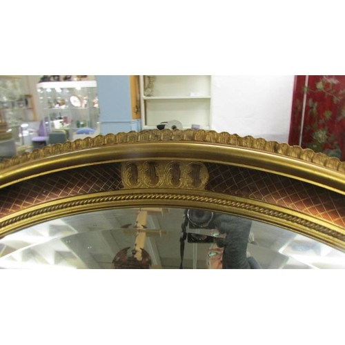 1551 - A good quality oval gilt framed bevel edged mirror.