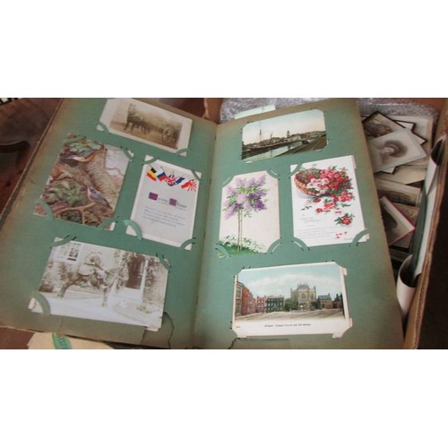 1557 - A box of postcards, photographs and ephemera.