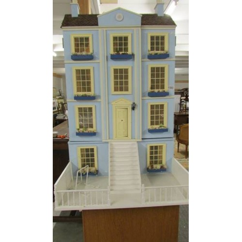 1560 - A Victorian style doll's house with furniture.