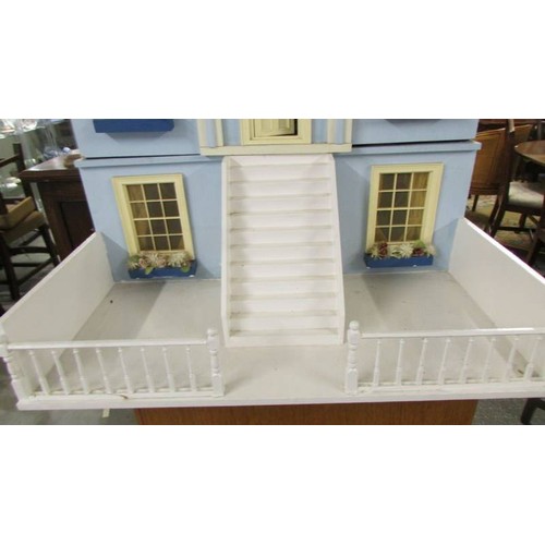 1560 - A Victorian style doll's house with furniture.