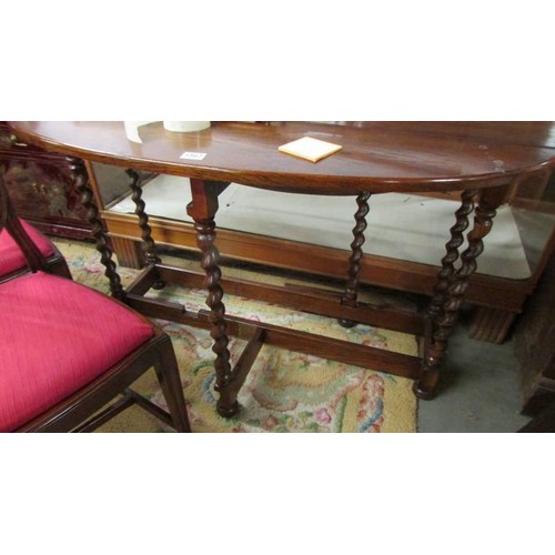 1567 - An oval oak barley twist gate leg table.