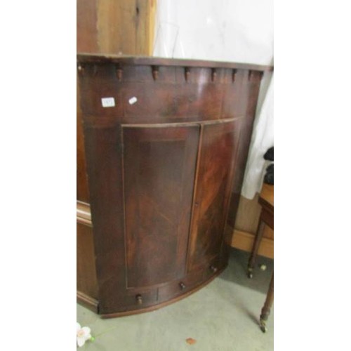 1572 - A Victorian bow front corner cupboard.