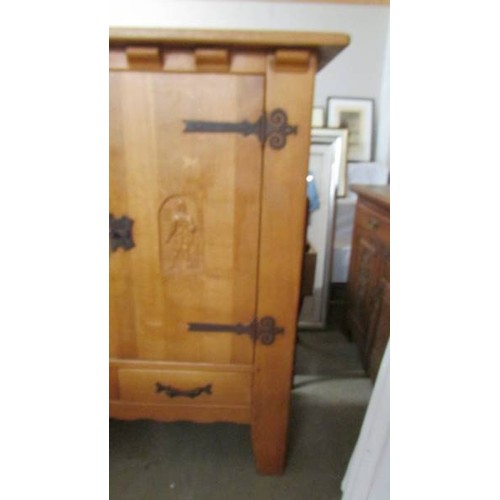 1583 - A light oak carved four door four drawer cupboard. (Very Heavy.) Collect only.