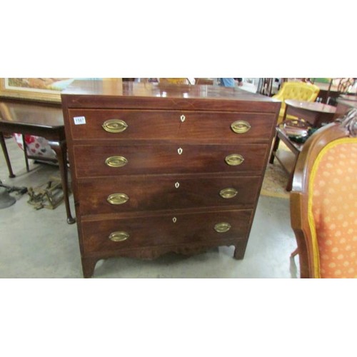 1587 - A four drawer mahogany chest with string inlay and brass handles.