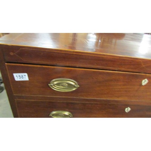 1587 - A four drawer mahogany chest with string inlay and brass handles.