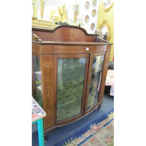 1601 - An Edwardian inlaid bow front display cabinet.