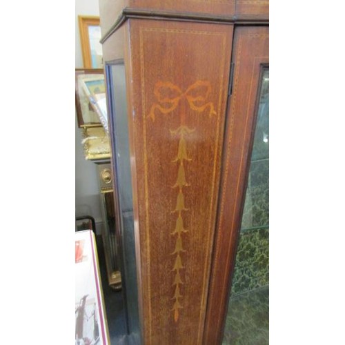 1601 - An Edwardian inlaid bow front display cabinet.