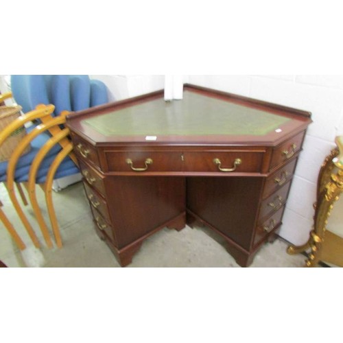 1607 - A mahogany corner fitting desk.