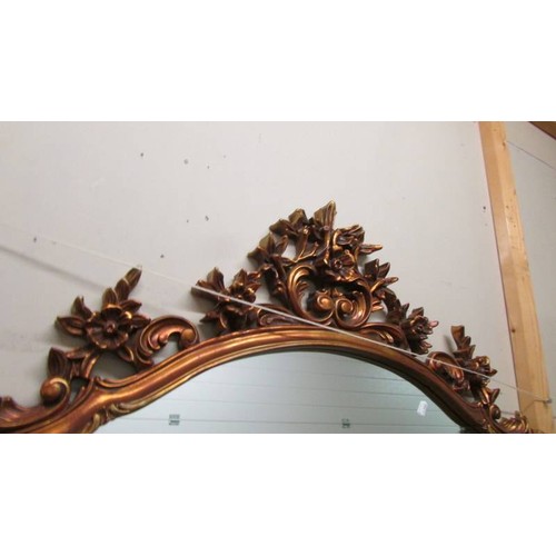 1608 - An ornate gilt framed overmantel mirror.