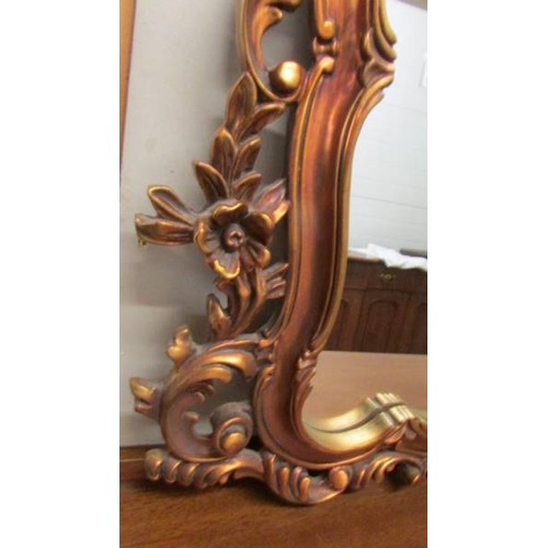 1608 - An ornate gilt framed overmantel mirror.