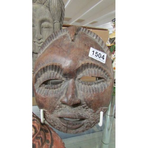 1503 - Two wooden wall masks and another wooden item.