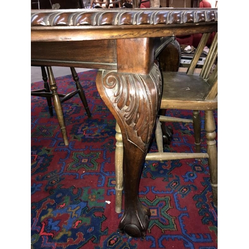 363 - A Victorian mahogany oval wind-out dining table with carved rope edges and Claw and Ball castered fe... 