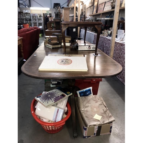 407 - A dark wood stained extending dining table on twin tripod base with brass lion paws feet