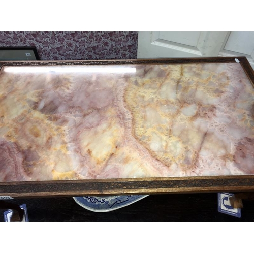 413 - A teak framed pink marble top coffee table (99cm x 54cm x 42cm high) *Collect Only*