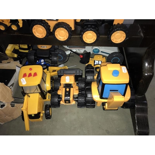 416 - A good selection of battery operated JCB construction vehicles, Porsche & TTA remote central toys (w... 