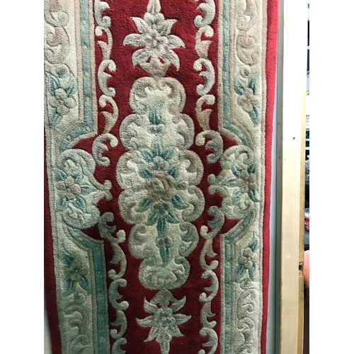 419 - An ornamental style red & cream coloured runner/rug (approximately 237cm  long x 69cm wide) (COLLECT... 