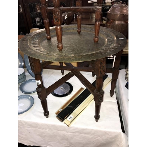 436 - A large Indian brass topped folding table & 1 other