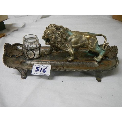 516 - An antique inkstand mounted with a lion and a brass dog,.