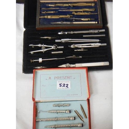 522 - Two part geometry sets and a pen set.