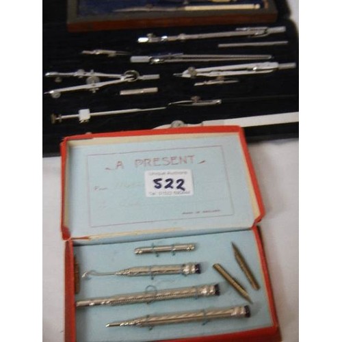 522 - Two part geometry sets and a pen set.