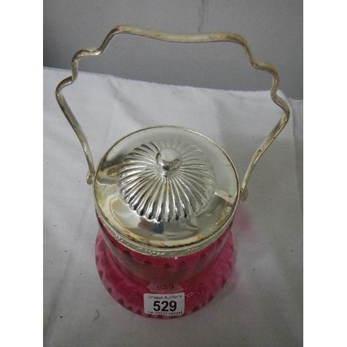 529 - A cranberry glass biscuit barrel with plated fittings.