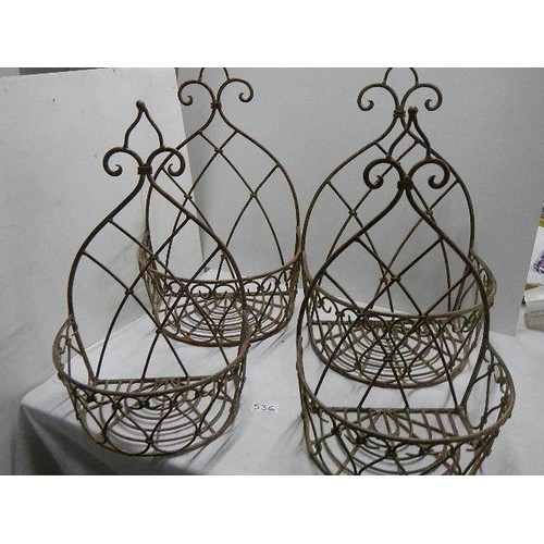 536 - Four metal wall hanging baskets.