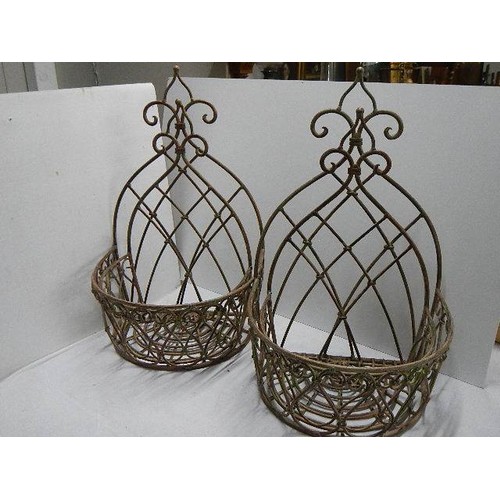 536 - Four metal wall hanging baskets.