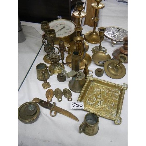 550 - A mixed lot of brass ware including candlesticks, pressure gauge etc.,