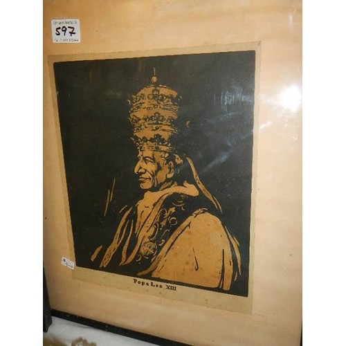 597 - A framed and glazed portrait of Pope Leo XIII and another religious print.