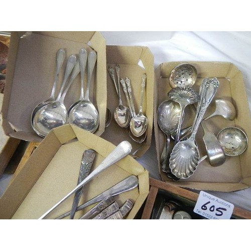 605 - A mixed lot of flatware including set of six spoons.