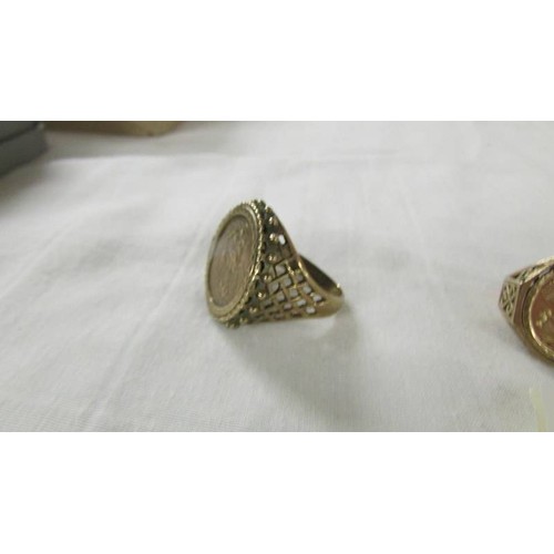 1013 - Three gold rings set St. George medallions sizes M, Q and V, total weight 9.8 grams.