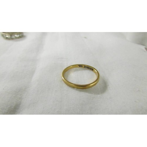 1014 - A 22ct gold wedding ring, size L, 2.1 grams and a 9ct gold eternity ring size L.