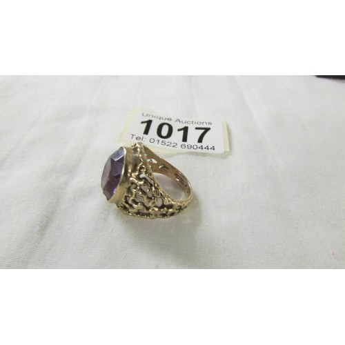 1017 - A 9ct gold ring set large amethyst coloured stone, size ). 8 grams.