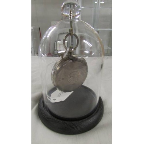 1105 - A silver pocket watch in plastic dome stand.