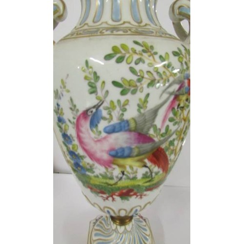 1203 - A lidded hand painted 19th century urn decorated with exotic bird, gold anchor mark to base, 38cm.