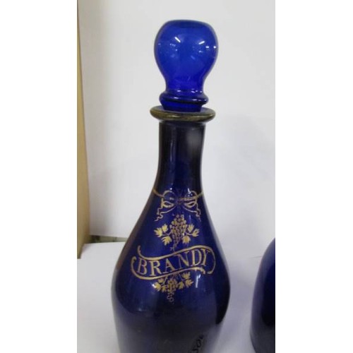 1206 - Two 19th century Bristol blue glass decanters (one missing stopper).