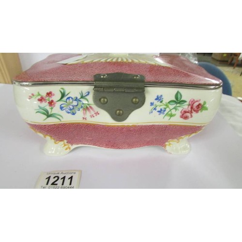 1211 - An English ceramic bird decorated box with plated fittings, 21 x 14 x 10 cm.