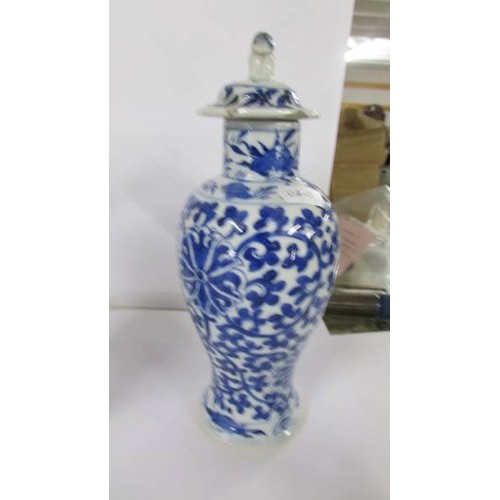 1213 - A pair of early Chinese blue & white lidded vases (both lids a/f) and a blue and white flask.