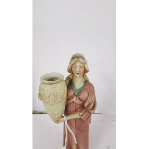 1218 - A Royal Dux figure of a woman with urn, 21 cm (chips to sleeve of dress).